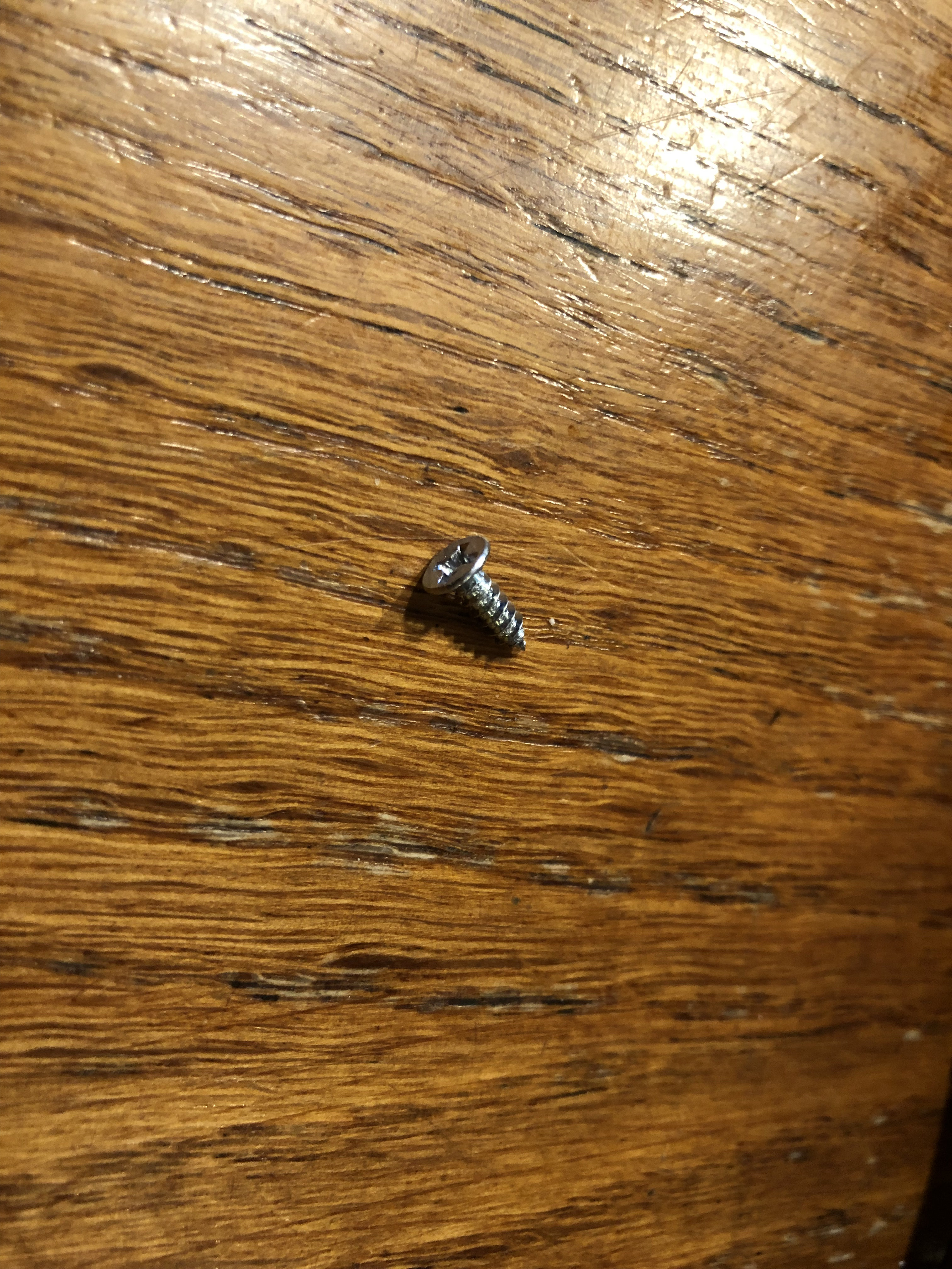 Small pointy screw from the bottom of the unit.