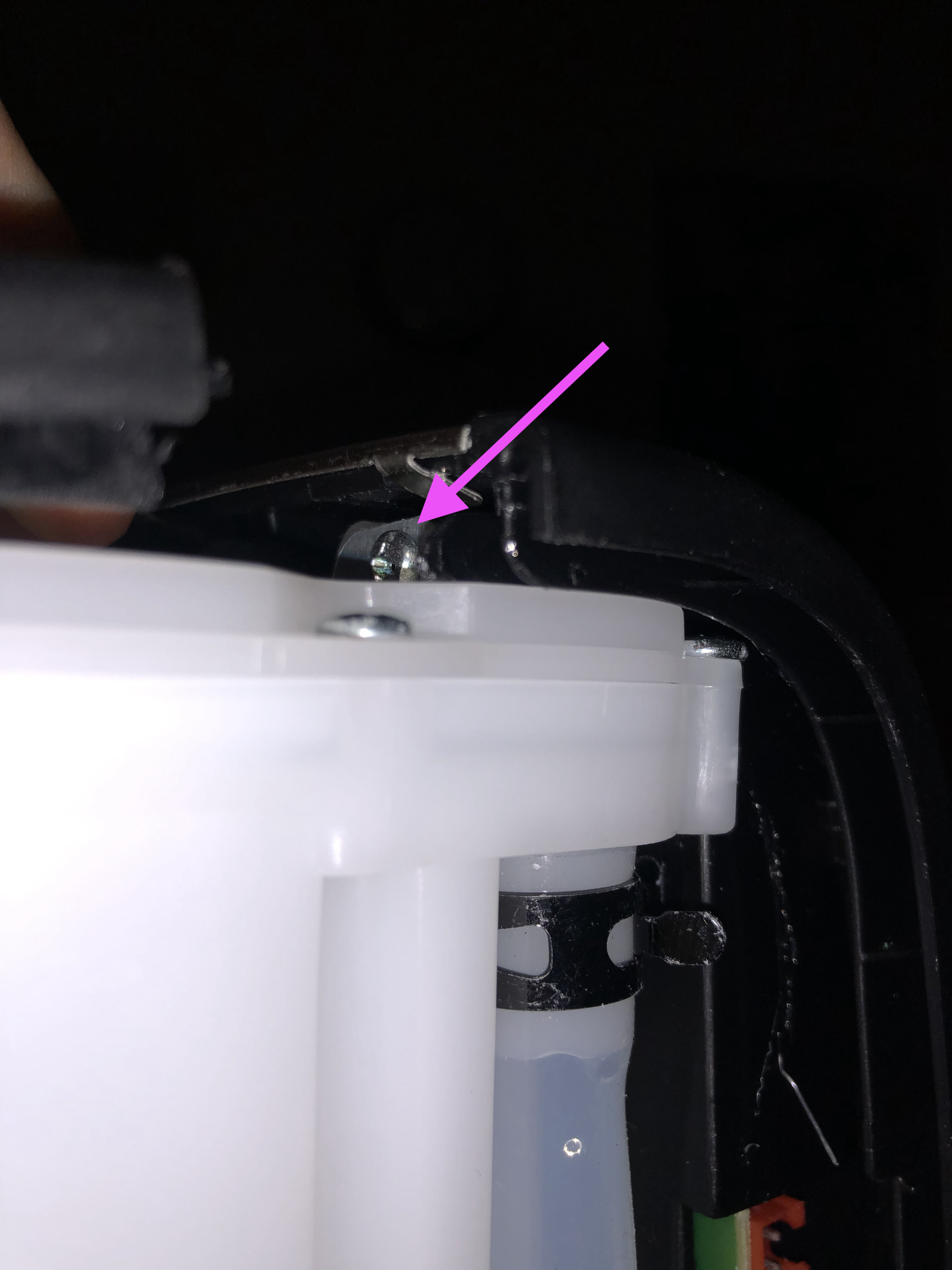 One of the screws securing the heating chamber