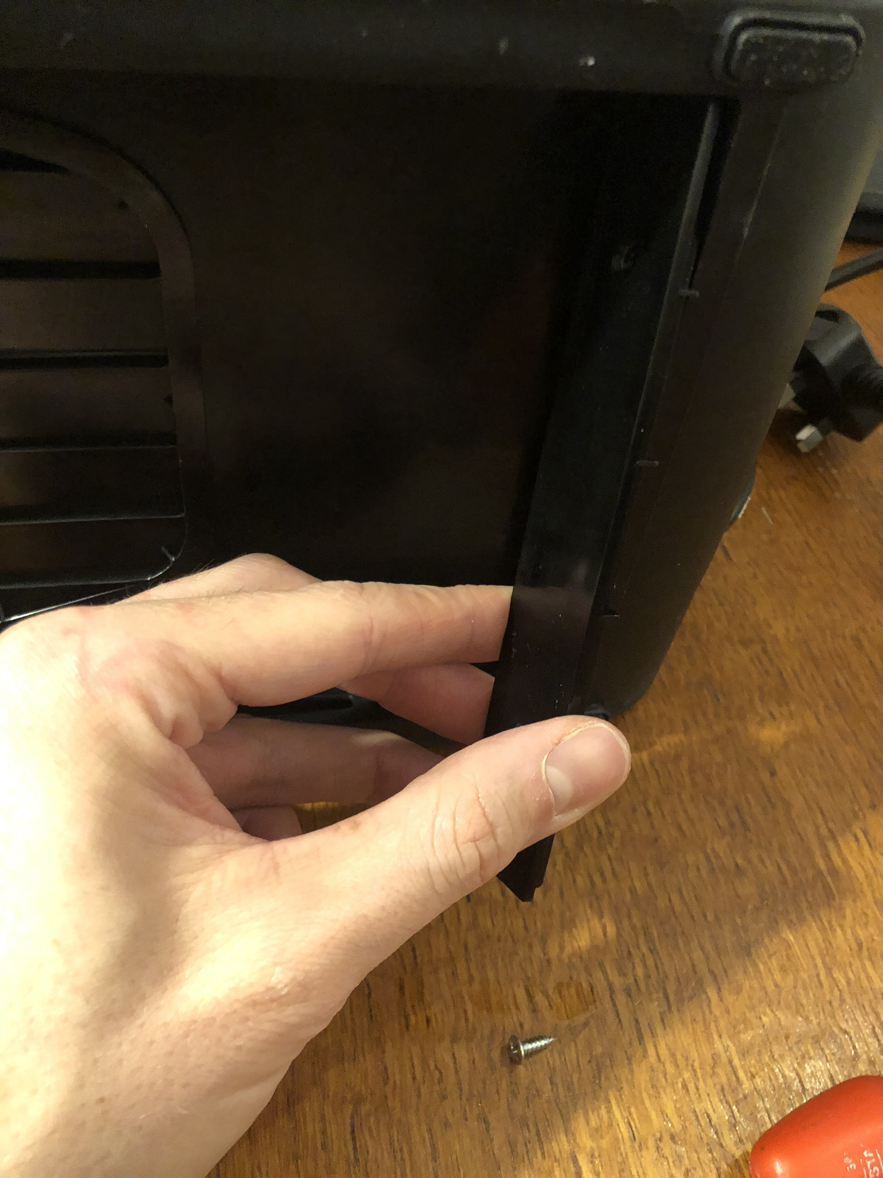 Uses the same little self-tapping screws as are under the rubber feet. re-fitting the final plastic piece.